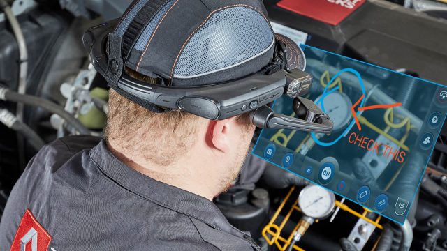 Renault Truck service technician conducts live video stream with a remote expert for troubleshooting and inspection, wearing RealWear HMT-1 running Librestream software.